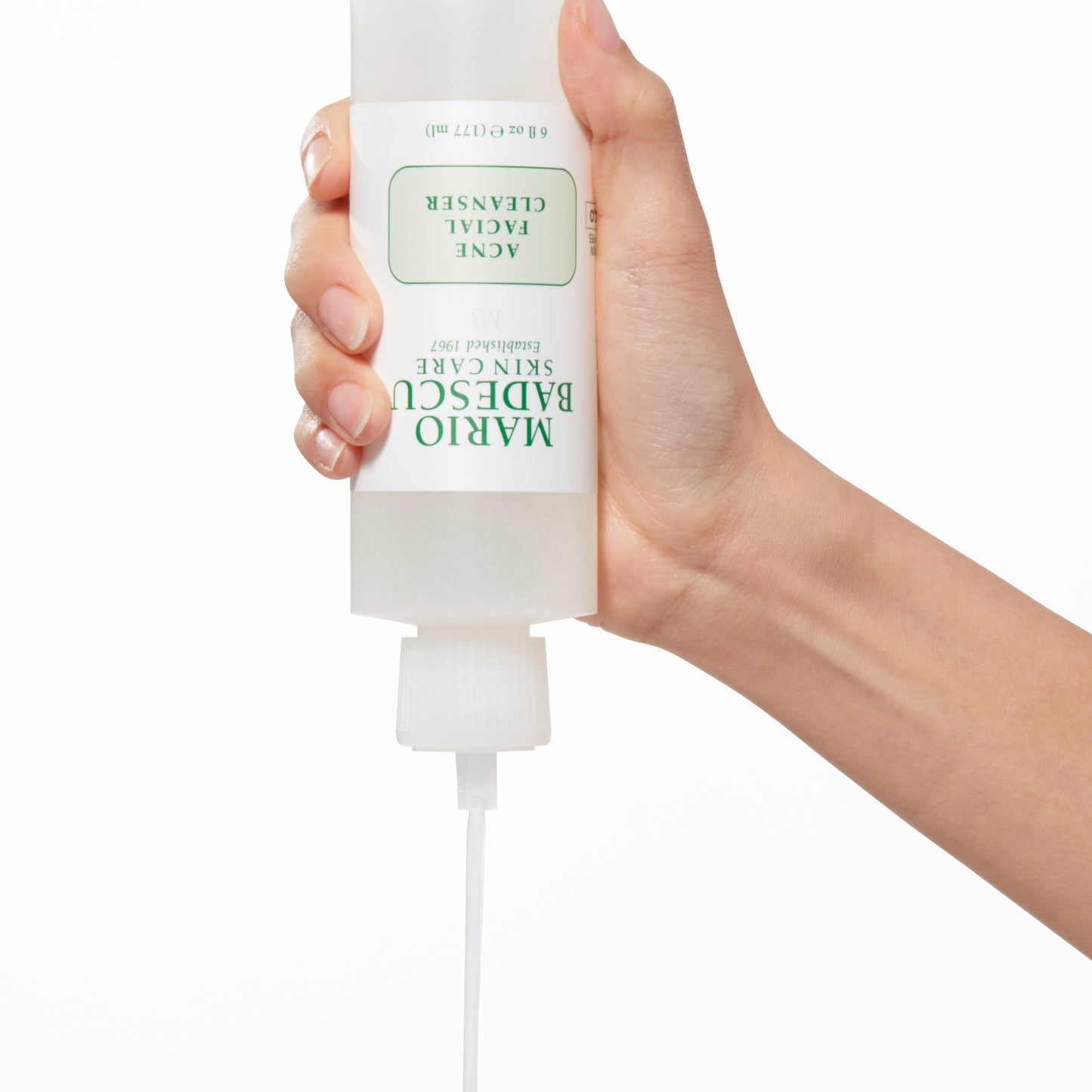 Demonstration showing a woman's hand squeezing Acne Facial Cleanser