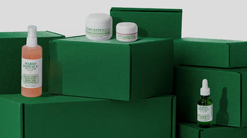 Mario Badescu skincare products on green boxes with a white background