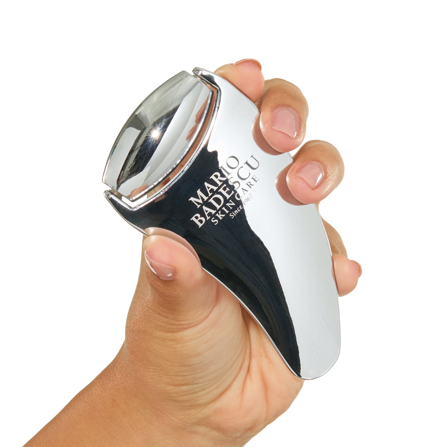 Hand holding a Mario Badescu skin care device against a white background