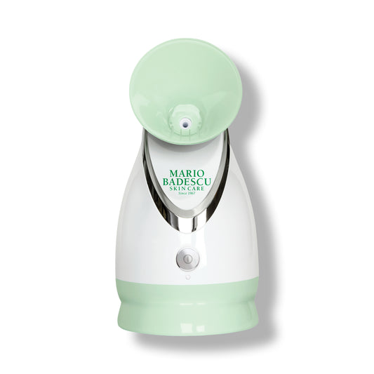 Green and white facial steamer with 'Mario Badescu' branding on a white background
